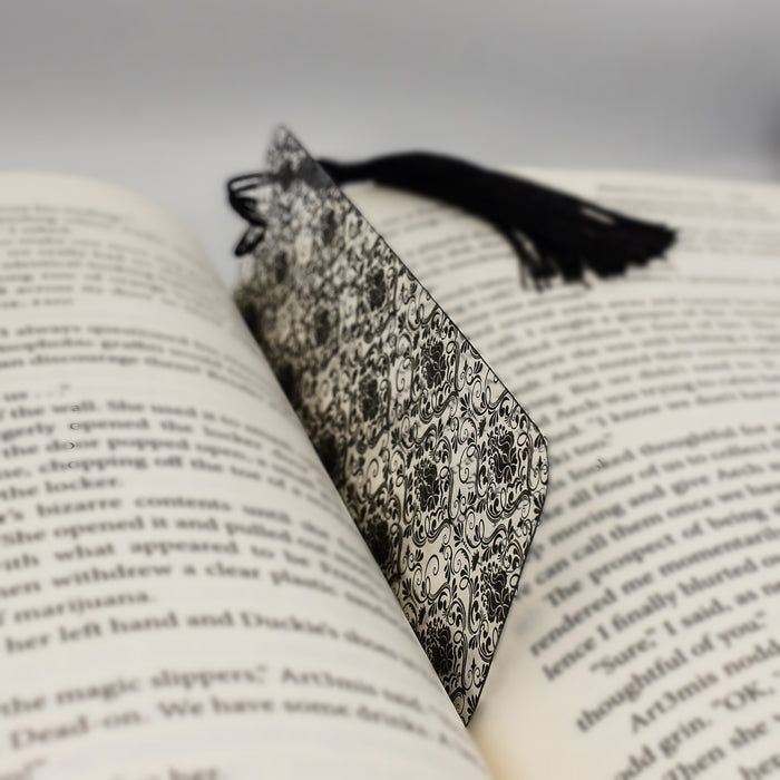 an open book with a tassel on top of it