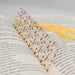 a book with a yellow tassel on top of it