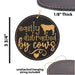 a leather ornament with the words easily distracted by cows