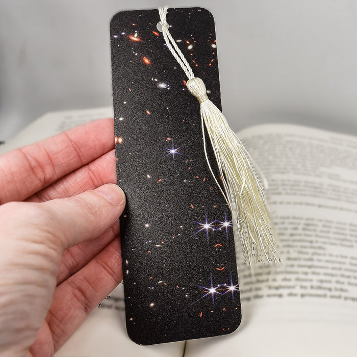 a bookmark with a tassel hanging from it