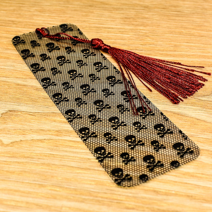 a piece of fabric with skulls and tassels on it