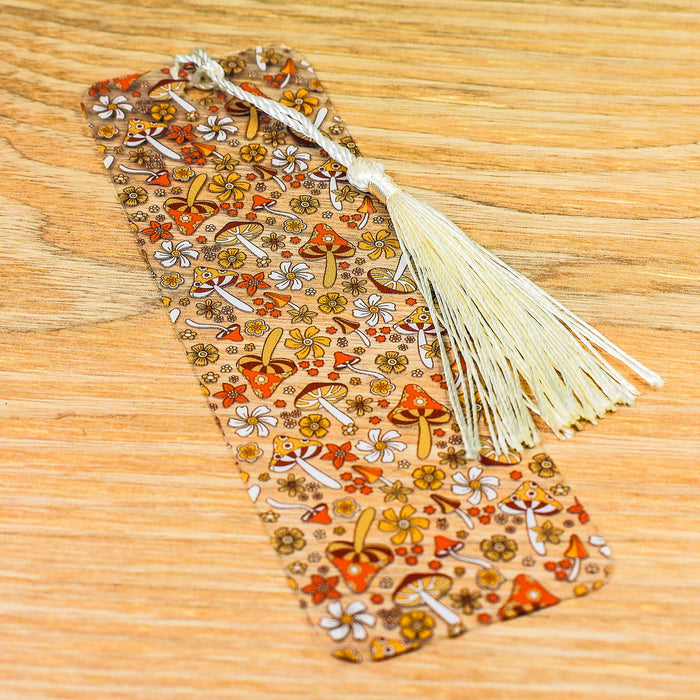 a bookmark with a tassel on a wooden table