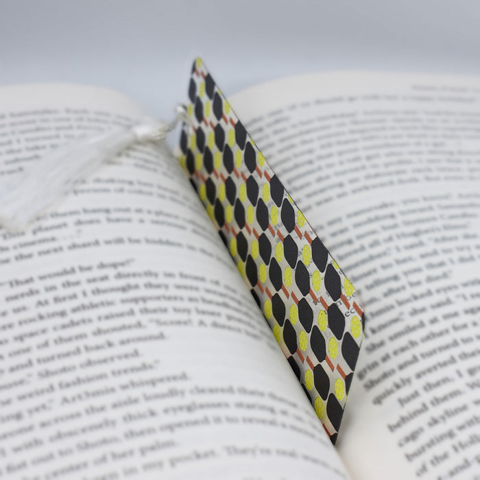 an open book with a tie on top of it