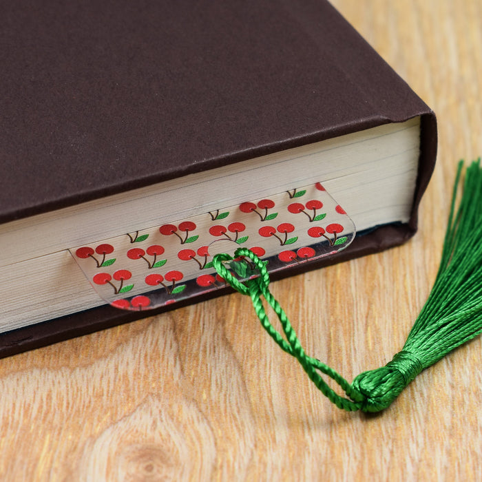 a book with a green tassel on top of it