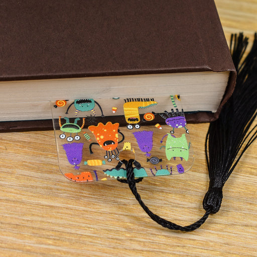 a book with a bookmark with a picture of monsters on it