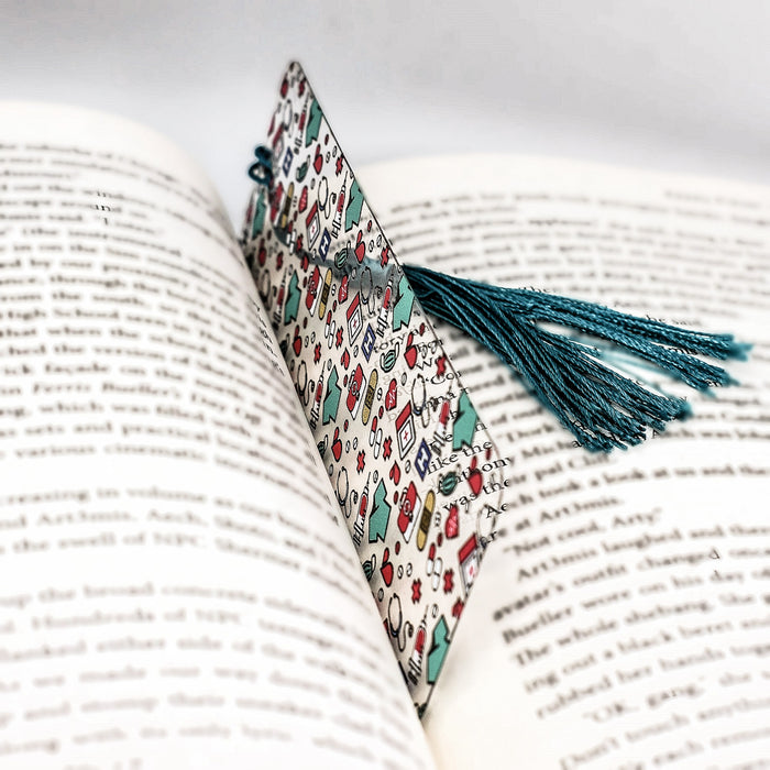 an open book with a tassel on top of it