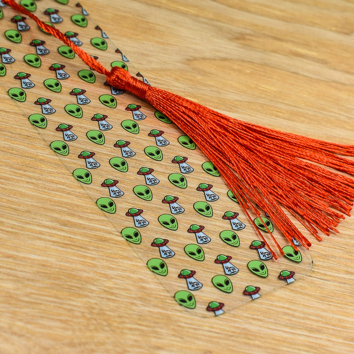 a wooden table topped with a red tassel