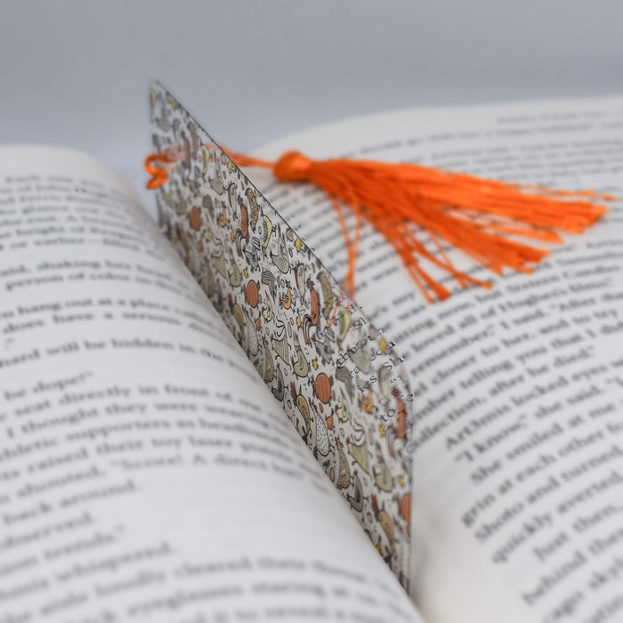 an open book with a tassel on top of it