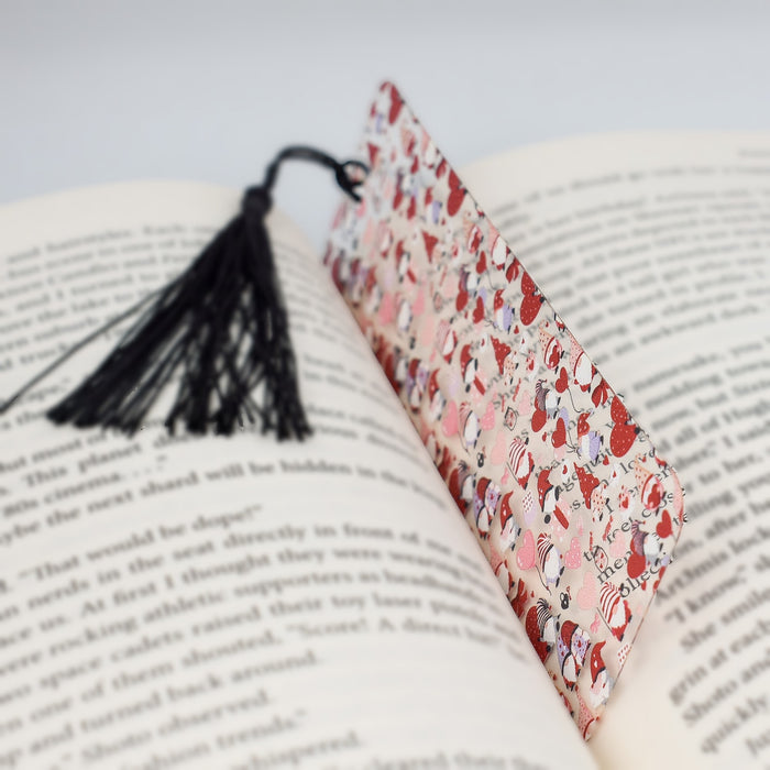 an open book with a tassel on top of it