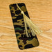 a bookmark with a tassel on a wooden table