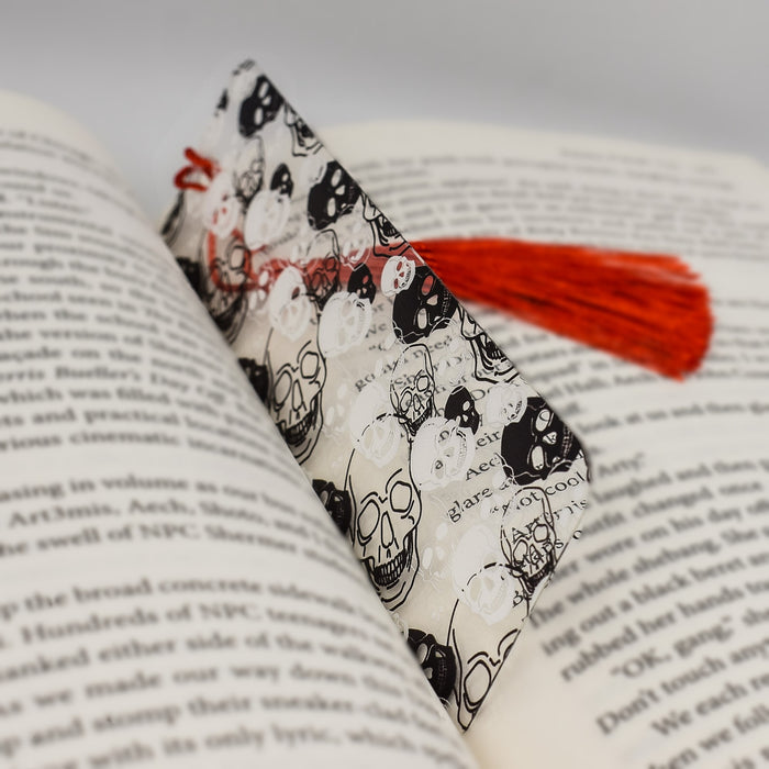 an open book with a red tassel on top of it