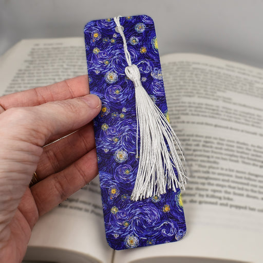 a hand holding a bookmark made out of a book