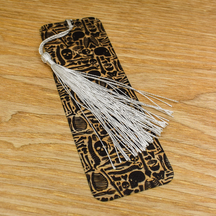 a bookmark with a tassel on top of a wooden table