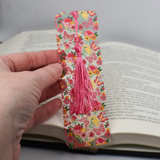 a person is holding a bookmark in their hand