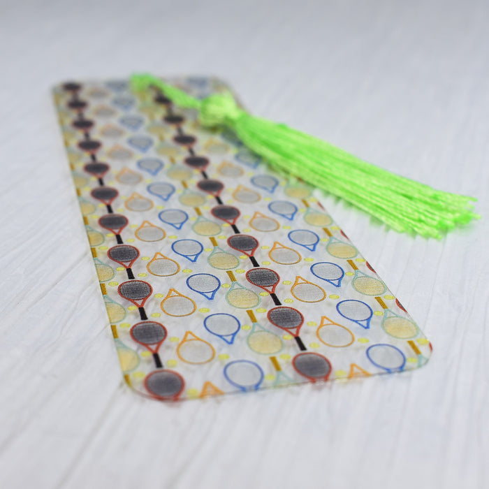 a tie with a green tassel is laying on a table