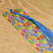 a colorful tie with a tassel on a wooden table