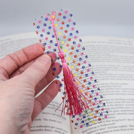 a person is holding a bookmark in their hand