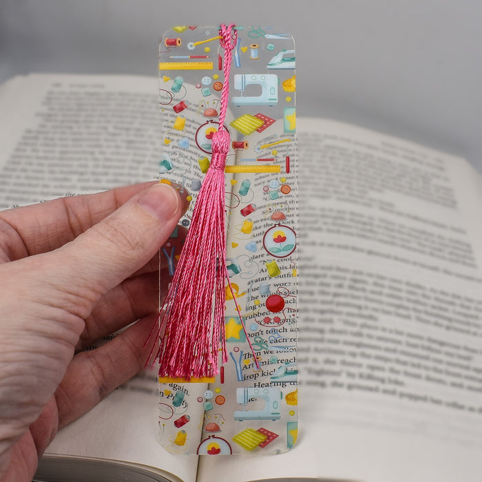 a person is holding a bookmark in their hand