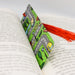 an open book with a red tassel on top of it