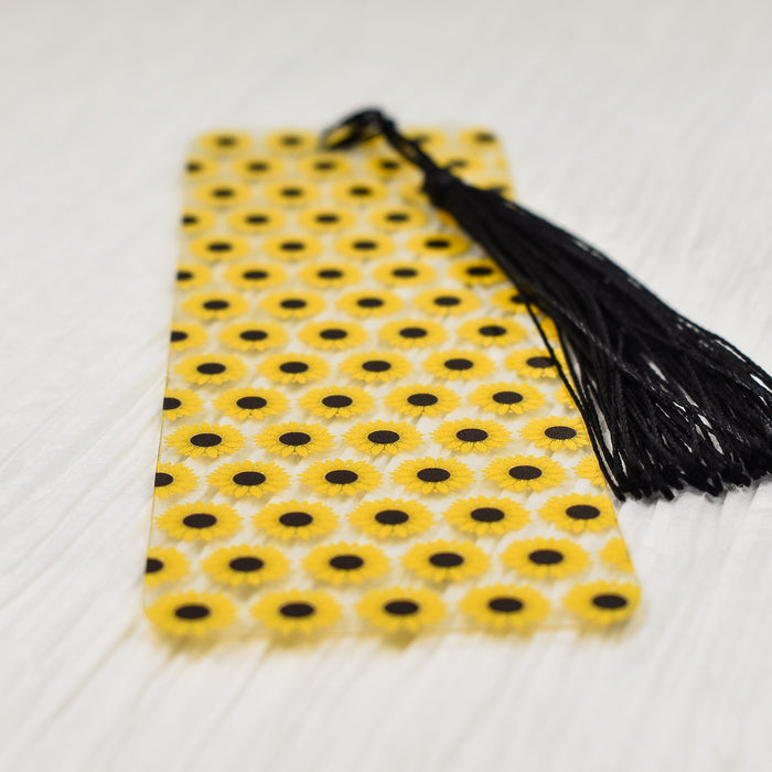 a yellow and black tie with a black tassel