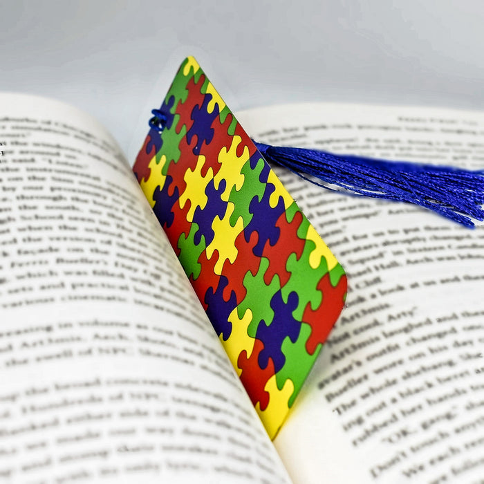 a colorful piece of puzzle sitting on top of an open book