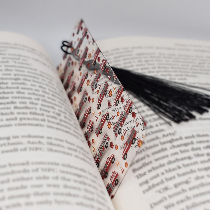 an open book with a tassel on top of it