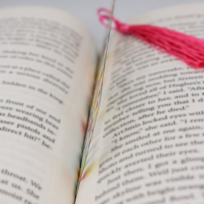 a close up of a book with a tassel on top of it