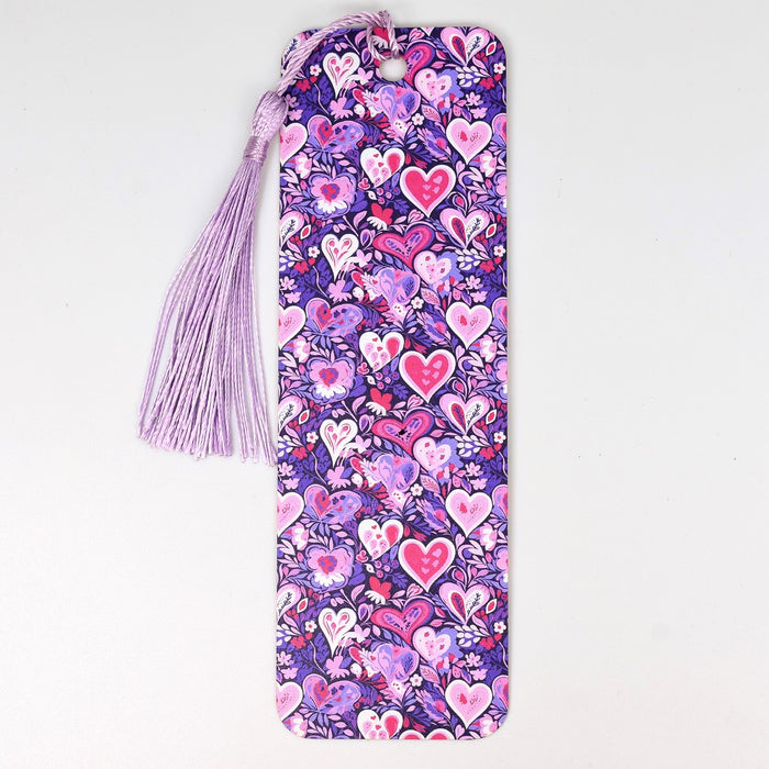 a purple bookmark with hearts and a tassel