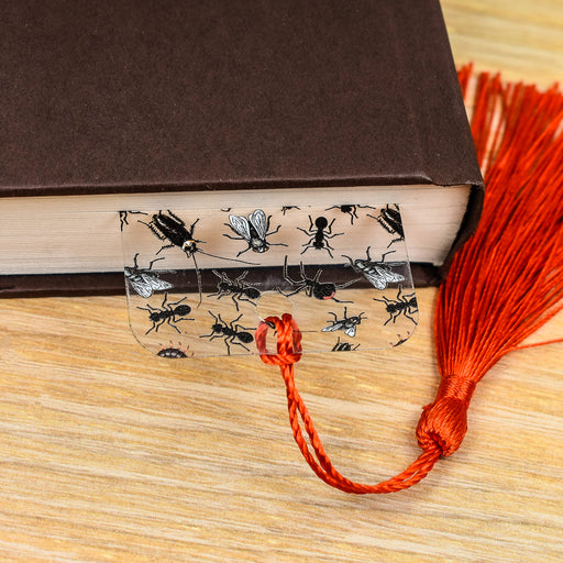 a close up of a book on a table with a tassel