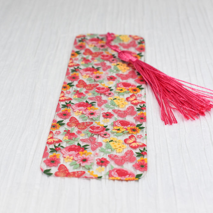 a tie with a flower pattern and a pink tassel