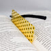 a yellow bookmark with black dots on it