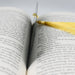 a book with a yellow tassel and a pair of scissors