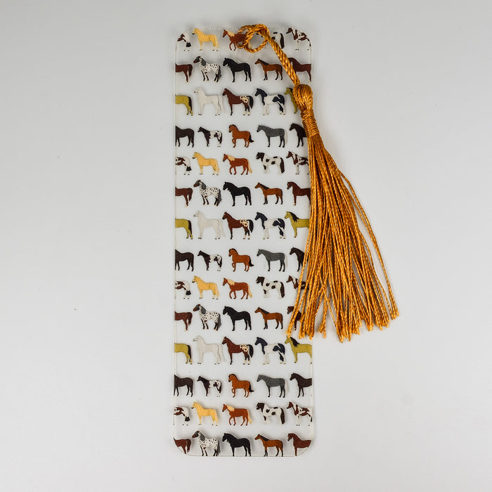 a bookmark with horses on it and a tassel