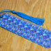 a blue and purple tie laying on top of a wooden table