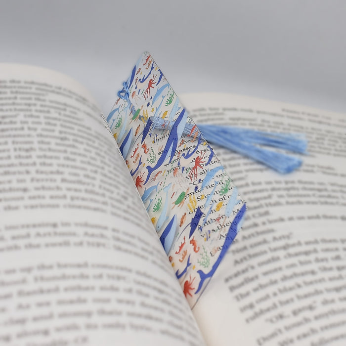 a book with a blue tassel on top of it