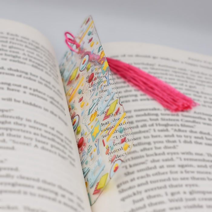 an open book with a tassel on top of it