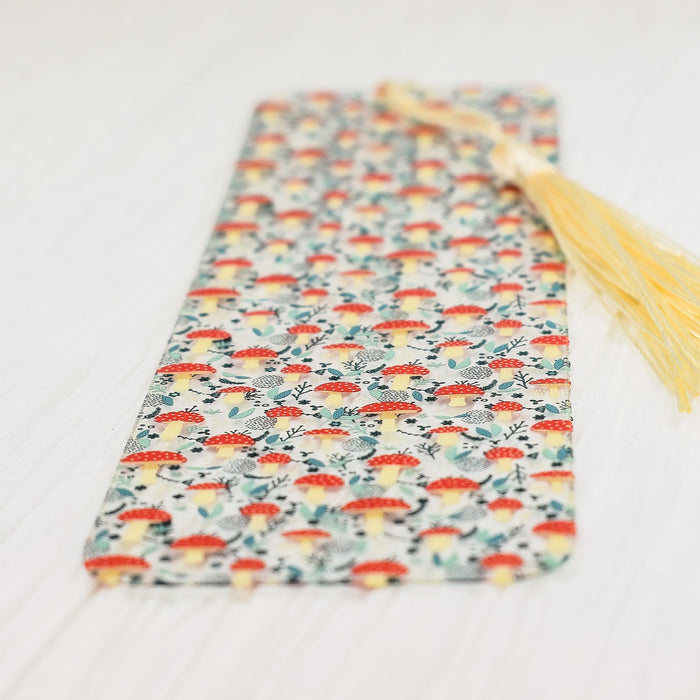 a tie laying on a table with a tassel