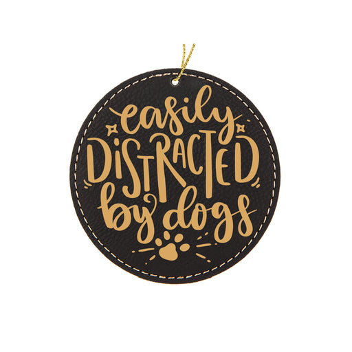 a black and gold ornament that says easily distracted by dogs