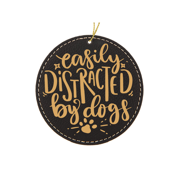a black and gold ornament that says easily distracted by dogs