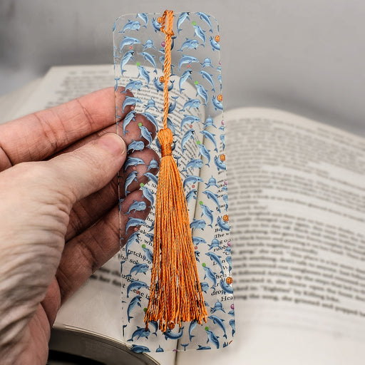 a person is holding a book with a tassel on it