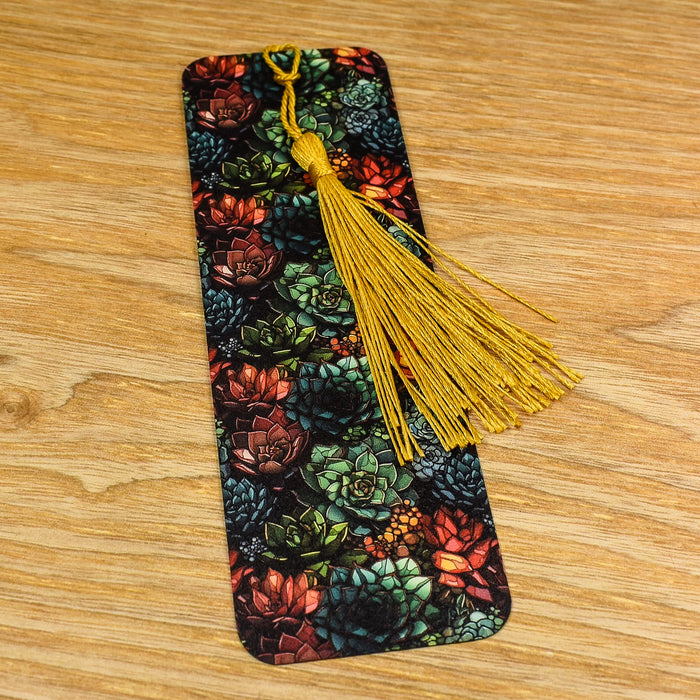 a bookmark with a yellow tassel on a wooden table