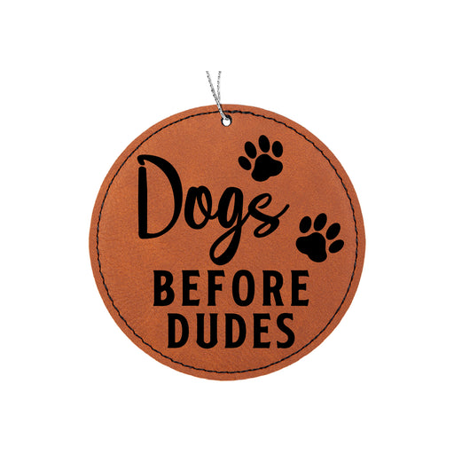 a leather ornament that says dogs before dudes