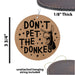 a leather ornament with the words don't pet the donkey on it