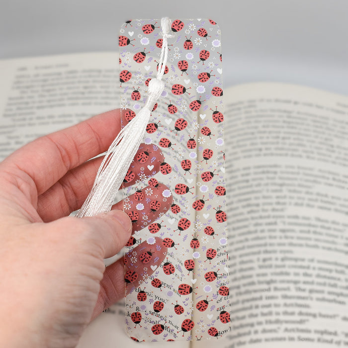 a person is holding a bookmark in their hand