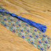 a blue tassel on a wooden table