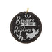 a black and white ornament with the words beware of tiny raptors