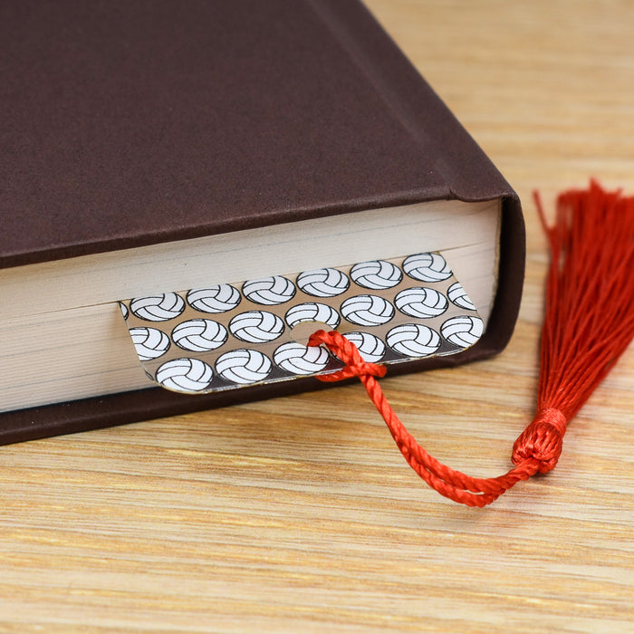 a book with a red tassel on top of it