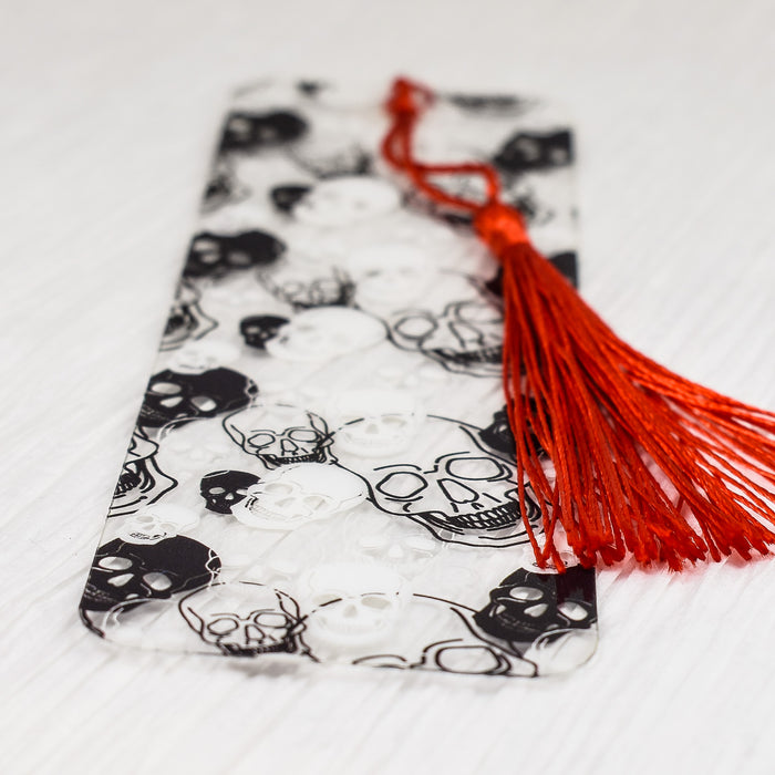 a bookmark with a red tassel on top of it