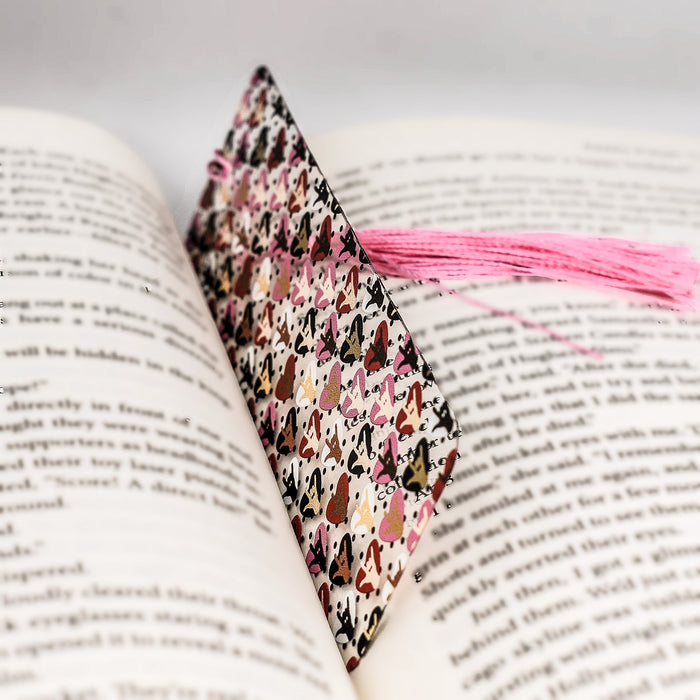 a book with a pink tassel on top of it