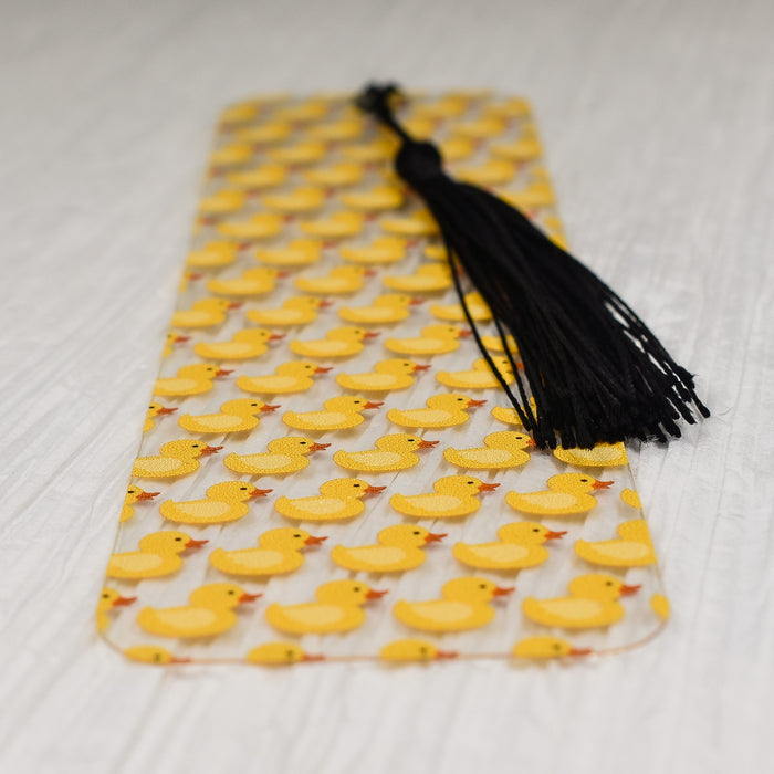 a yellow rubber ducky pattern with a black tassel